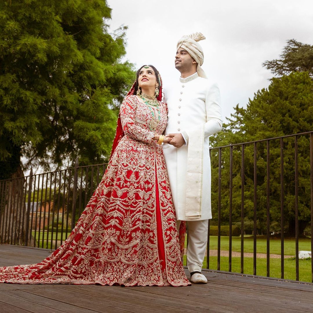 RED LONG TRAIL ANARKALI BRIDAL LEHENGA WITH EMBELLISHMENT - DN-1976