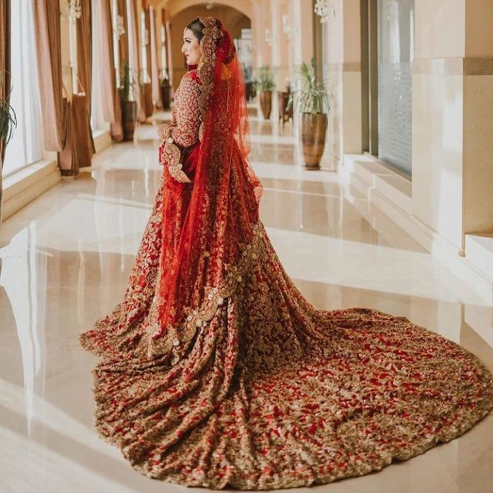 TRADITIONAL PAKISTANI LONG TRAIL BRIDAL LEHENGA WITH GOLDEN EMBROIDERY - DN-1679